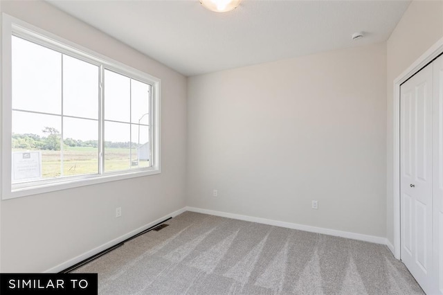 unfurnished bedroom featuring carpet, a closet, and baseboards