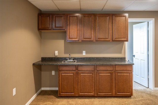 15046 Summit Dr, Clive, IA 50325 - kitchen featuring light carpet, dark countertops, a drop ceiling, and brown cabinets