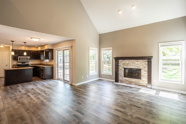 15046 Summit Dr, Clive, IA 50325 - unfurnished living room with high vaulted ceiling, dark wood finished floors, and a fireplace