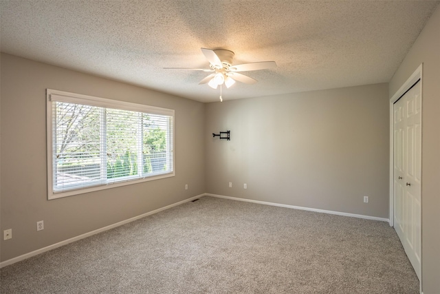 15046 Summit Dr, Clive, IA 50325 - unfurnished bedroom with carpet flooring, a textured ceiling, a closet, and ceiling fan