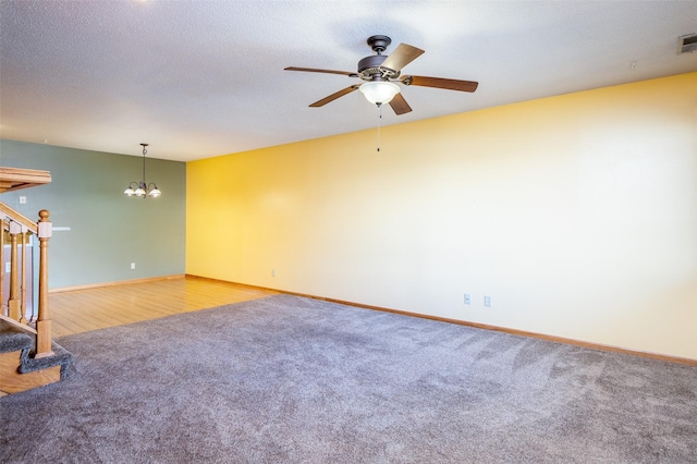 1509 SE Delaware Ave Unit 10, Ankeny, IA 50021 - empty room with stairs, baseboards, ceiling fan, carpet floors, and a chandelier