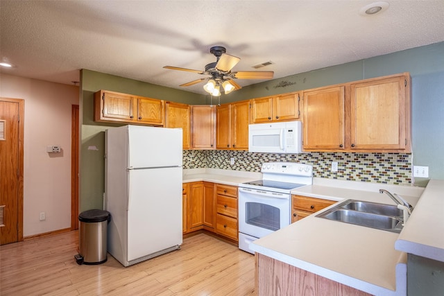 1509 SE Delaware Ave Unit 10, Ankeny, IA 50021 - kitchen with white appliances, a sink, light wood finished floors, tasteful backsplash, and recessed lighting