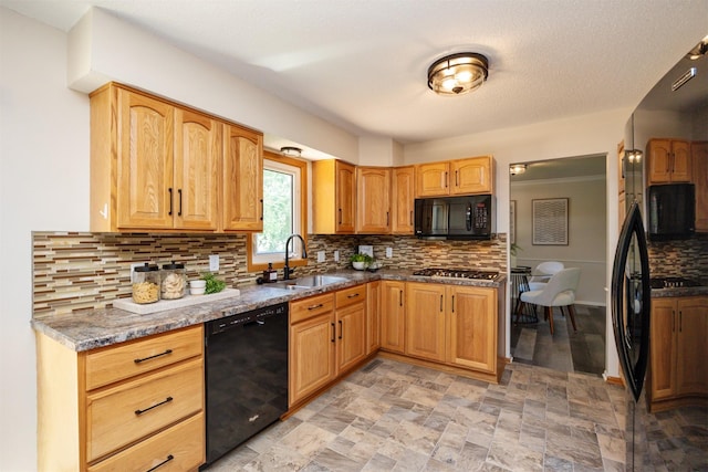 10476 Ricardo Rd, Clive, IA 50325 - kitchen with black appliances, a sink, decorative backsplash, light stone finish floors, and dark stone counters