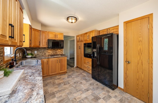 10476 Ricardo Rd, Clive, IA 50325 - kitchen featuring black appliances, a sink, backsplash, and stone finish flooring