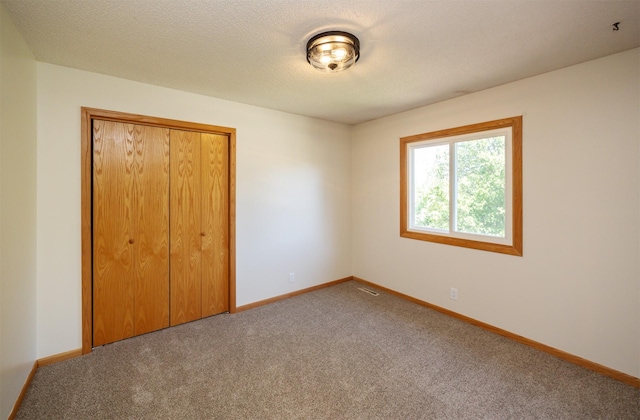 10476 Ricardo Rd, Clive, IA 50325 - unfurnished bedroom with carpet flooring, a closet, and baseboards