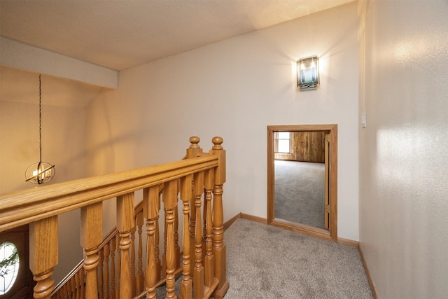 10476 Ricardo Rd, Clive, IA 50325 - hallway with carpet flooring, baseboards, an upstairs landing, and lofted ceiling