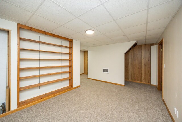 10476 Ricardo Rd, Clive, IA 50325 - finished basement with carpet flooring, a paneled ceiling, baseboards, and wooden walls