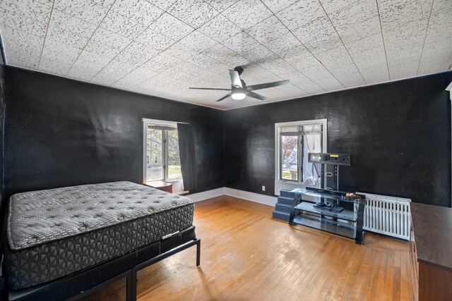 910 Washington St, Eldora, IA 50627 - bedroom featuring hardwood / wood-style flooring, baseboards, and ceiling fan