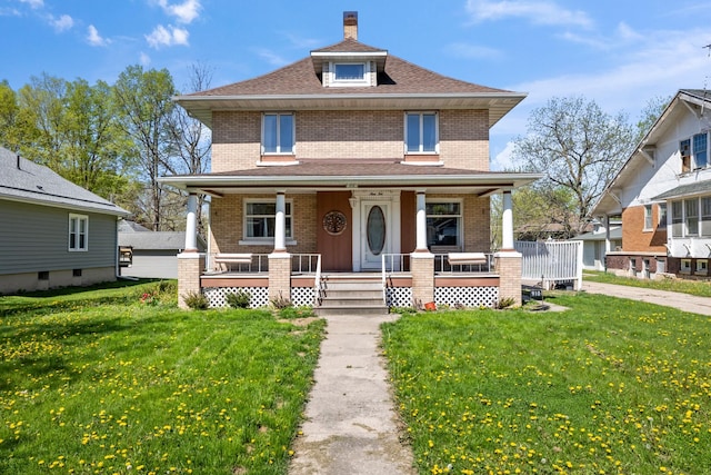 910 Washington St, Eldora, IA 50627 - traditional style home with brick siding, a front yard, and covered porch