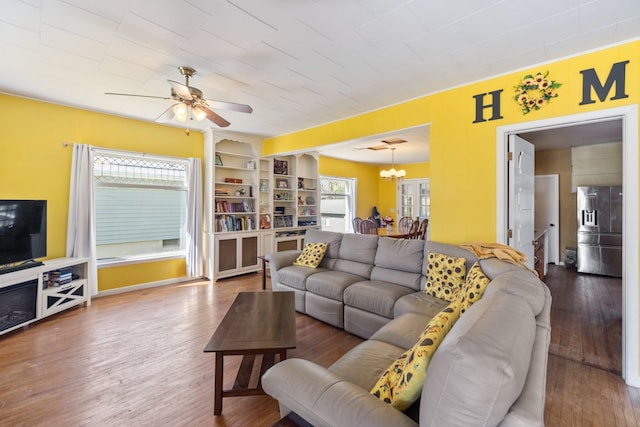 910 Washington St, Eldora, IA 50627 - living area with a ceiling fan, wood finished floors, a chandelier, and built in shelves