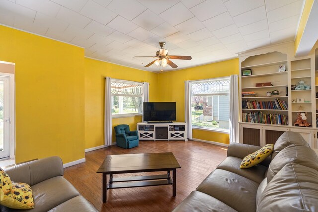 910 Washington St, Eldora, IA 50627 - living area with ceiling fan, baseboards, wood finished floors, and ornamental molding