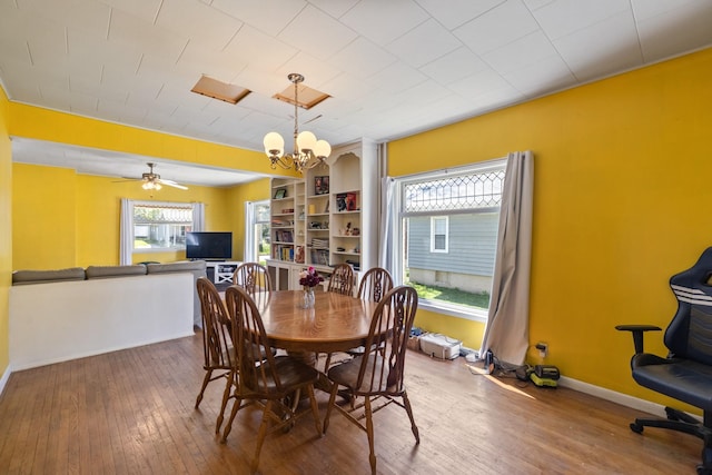 910 Washington St, Eldora, IA 50627 - dining area featuring a chandelier, hardwood / wood-style flooring, baseboards, and a ceiling fan
