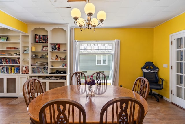 910 Washington St, Eldora, IA 50627 - dining room featuring a chandelier and wood finished floors