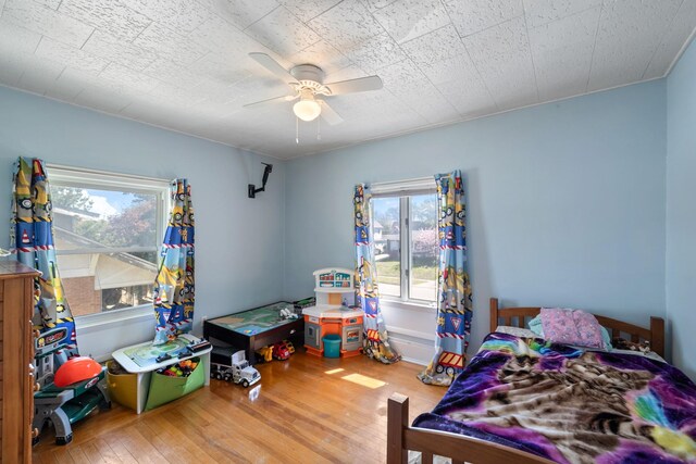 910 Washington St, Eldora, IA 50627 - bedroom featuring hardwood / wood-style flooring and ceiling fan