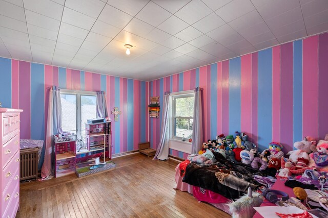 910 Washington St, Eldora, IA 50627 - bedroom featuring wallpapered walls and hardwood / wood-style flooring