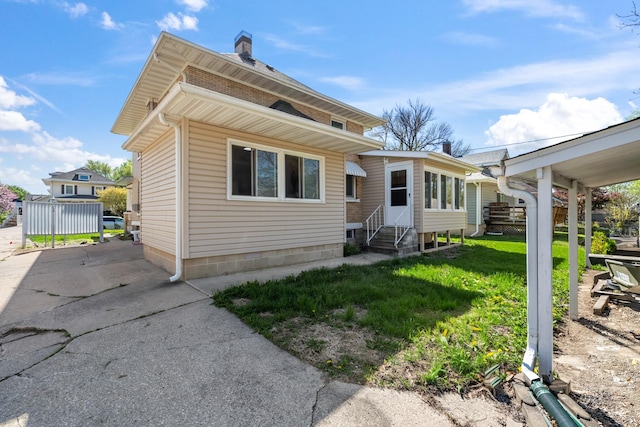 910 Washington St, Eldora, IA 50627 - rear view of house featuring entry steps and a chimney