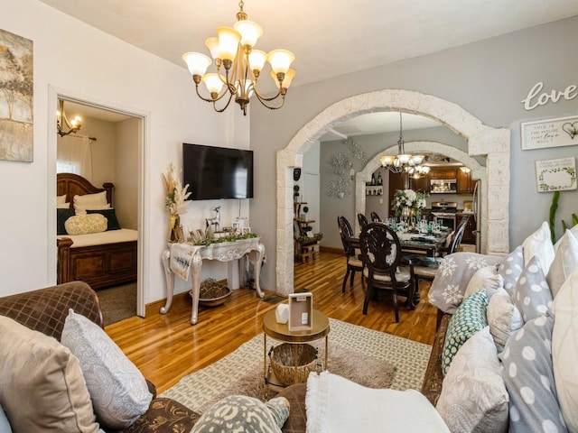 1273 E 18th St, Des Moines, IA 50316 - living area with a chandelier, arched walkways, and wood finished floors