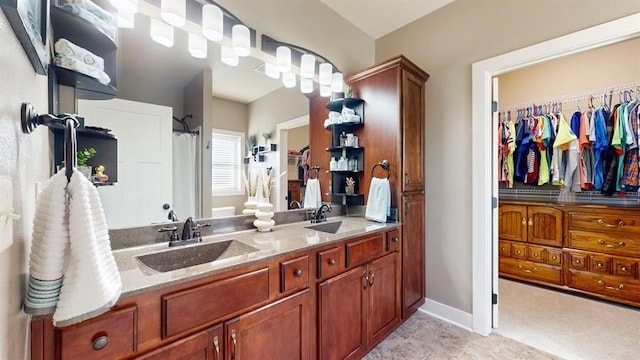 bathroom featuring double vanity, curtained shower, and baseboards