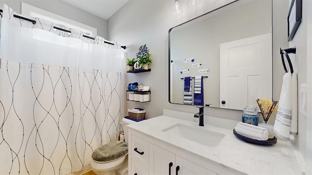 bathroom featuring vanity, toilet, and a shower with shower curtain