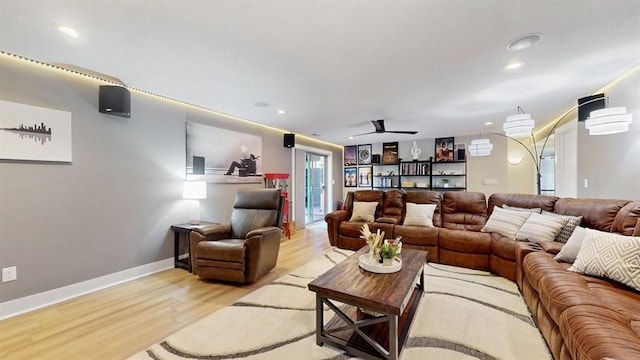 living room with light wood-style flooring, ceiling fan, and recessed lighting