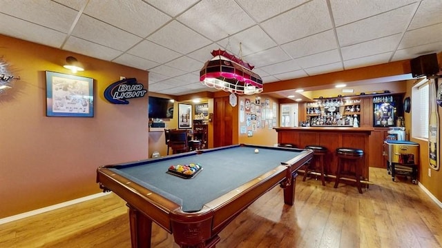 game room featuring a dry bar, baseboards, wood finished floors, pool table, and a paneled ceiling