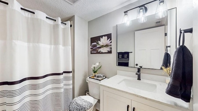 bathroom with a textured ceiling, vanity, toilet, and a shower with curtain