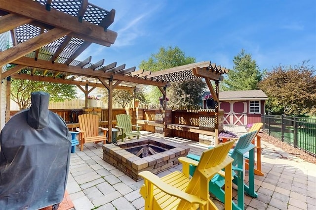 view of patio featuring an outdoor fire pit, a storage shed, a grill, a fenced backyard, and an outdoor structure
