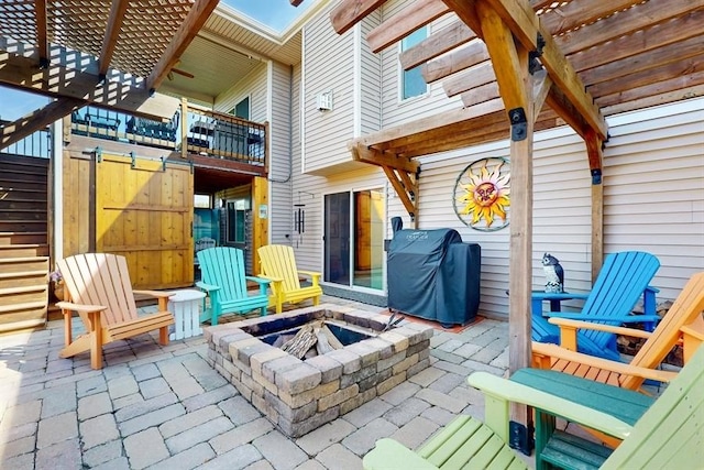 view of patio / terrace with a fire pit, area for grilling, and a pergola