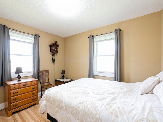 bedroom featuring light wood-style floors and multiple windows