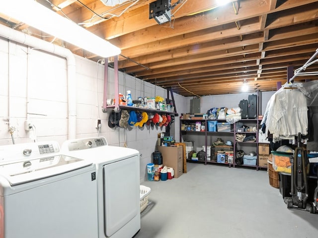 unfinished basement with washer and dryer and concrete block wall
