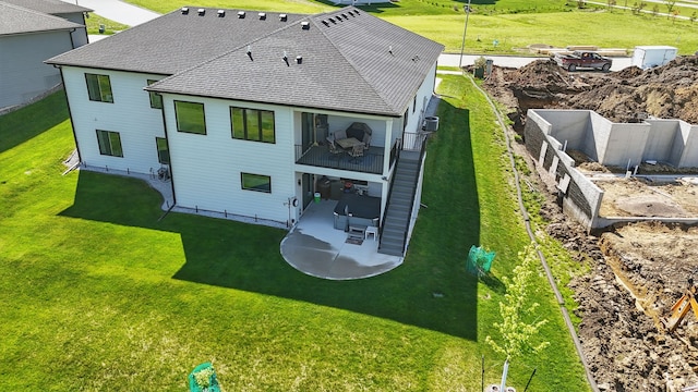 425 NW Woodmoor Dr, Waukee, IA 50263 - back of property featuring a patio and a shingled roof