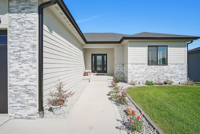 425 NW Woodmoor Dr, Waukee, IA 50263 - entrance to property with stone siding, a lawn, and roof with shingles
