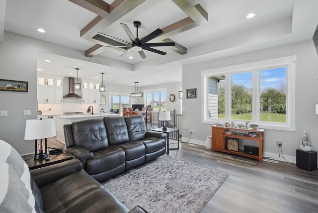 425 NW Woodmoor Dr, Waukee, IA 50263 - living room featuring coffered ceiling, ceiling fan, recessed lighting, light wood-type flooring, and baseboards