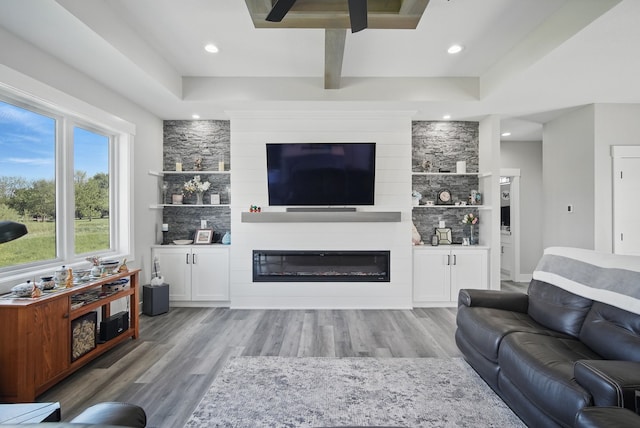 425 NW Woodmoor Dr, Waukee, IA 50263 - living room featuring a glass covered fireplace, light wood-type flooring, ceiling fan, and recessed lighting