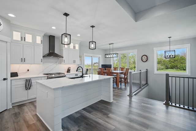 425 NW Woodmoor Dr, Waukee, IA 50263 - kitchen with wall chimney exhaust hood, a sink, stainless steel range with gas cooktop, recessed lighting, and glass insert cabinets