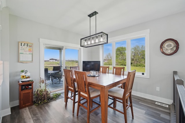 425 NW Woodmoor Dr, Waukee, IA 50263 - dining room with dark wood-style flooring and baseboards