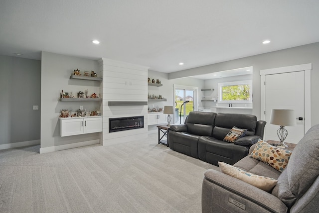 425 NW Woodmoor Dr, Waukee, IA 50263 - living room with light colored carpet, recessed lighting, a fireplace, and baseboards