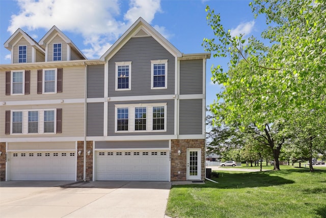 8302 Westown Pkwy Unit 10001, West Des Moines, IA 50266 - townhome / multi-family property featuring stone siding, driveway, a garage, and a front yard