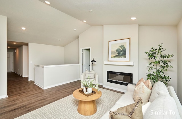 5560 165th St, Urbandale, IA 50323 - living room featuring wood finished floors, recessed lighting, baseboards, a glass covered fireplace, and lofted ceiling