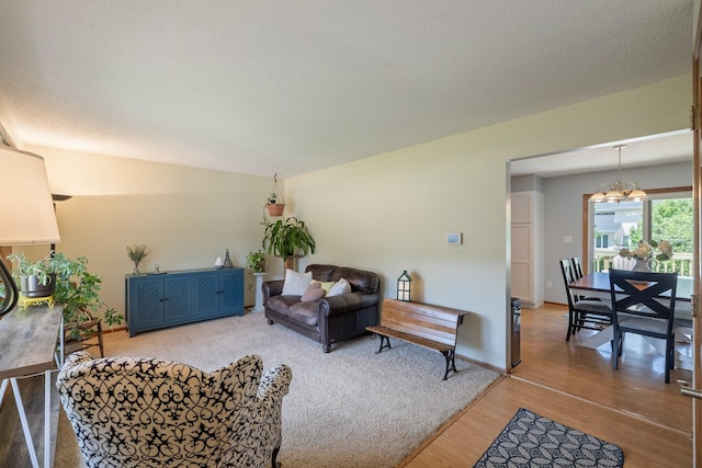 8123 Brookview Dr, Urbandale, IA 50322 - living area featuring a chandelier, wood finished floors, and a textured ceiling
