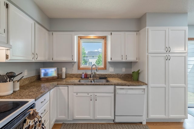 8123 Brookview Dr, Urbandale, IA 50322 - kitchen featuring white dishwasher, white cabinetry, dark stone countertops, and light wood-style flooring
