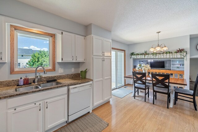 8123 Brookview Dr, Urbandale, IA 50322 - kitchen featuring white dishwasher, light wood-style flooring, healthy amount of natural light, a textured ceiling, and white cabinetry