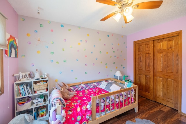 8123 Brookview Dr, Urbandale, IA 50322 - bedroom with wood finished floors, wallpapered walls, a closet, and a ceiling fan