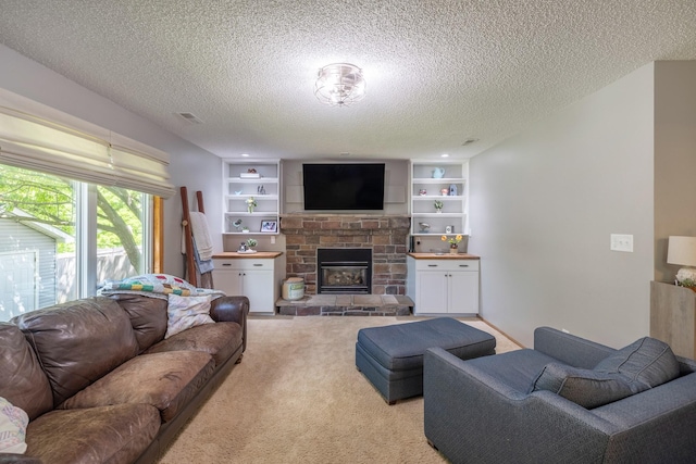 8123 Brookview Dr, Urbandale, IA 50322 - living area with a textured ceiling, a stone fireplace, light colored carpet, and built in features