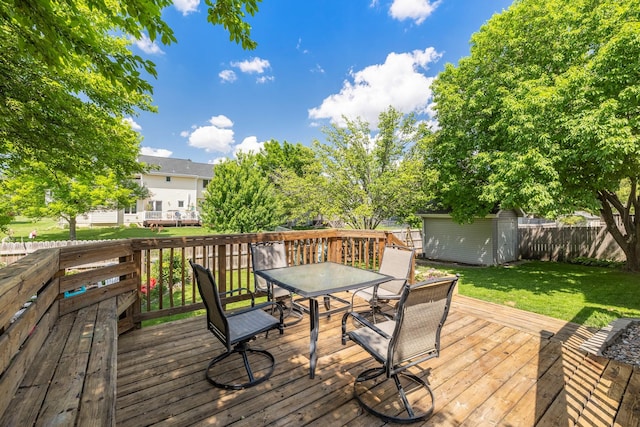 8123 Brookview Dr, Urbandale, IA 50322 - deck with outdoor dining area, a fenced backyard, and a storage shed