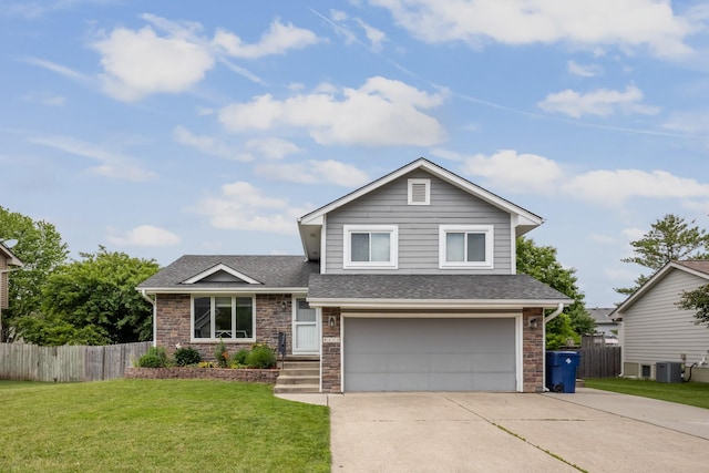 8123 Brookview Dr, Urbandale, IA 50322 - tri-level home with an attached garage, stone siding, concrete driveway, and roof with shingles