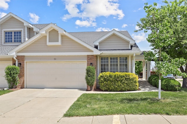 4400 Ep True Pkwy Unit 51, West Des Moines, IA 50265 - view of front of house featuring brick siding, driveway, a garage, and a shingled roof