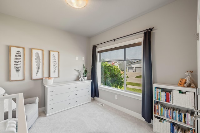 sitting room featuring light colored carpet and baseboards