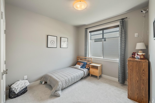 carpeted bedroom with baseboards
