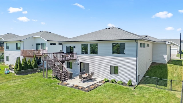 rear view of property with a deck, stairs, a patio area, and a shingled roof